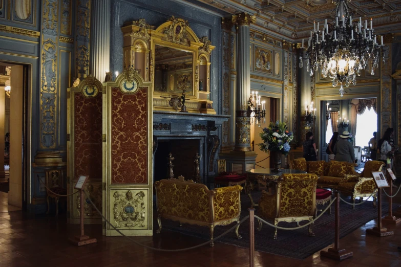 a formal room with chandeliers, tables and chairs