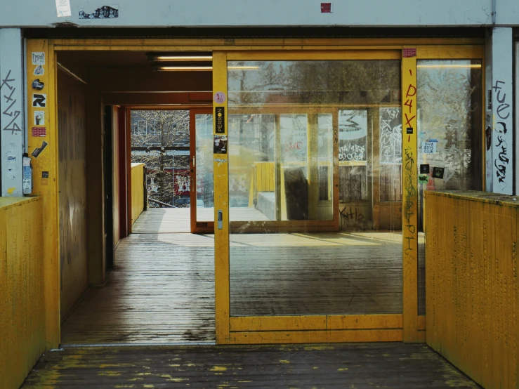 a door is opened inside of a yellow building