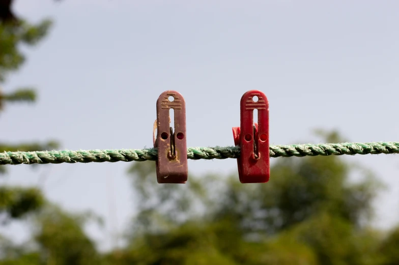 two pairs of red scissors attached to ropes