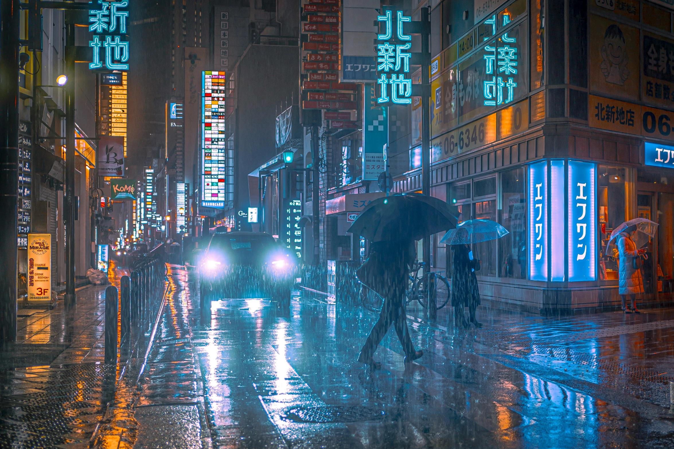 a group of people walking on a street in the rain