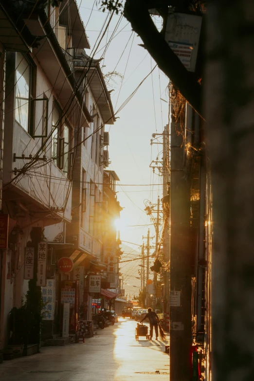 the street has cars parked on it during sunset