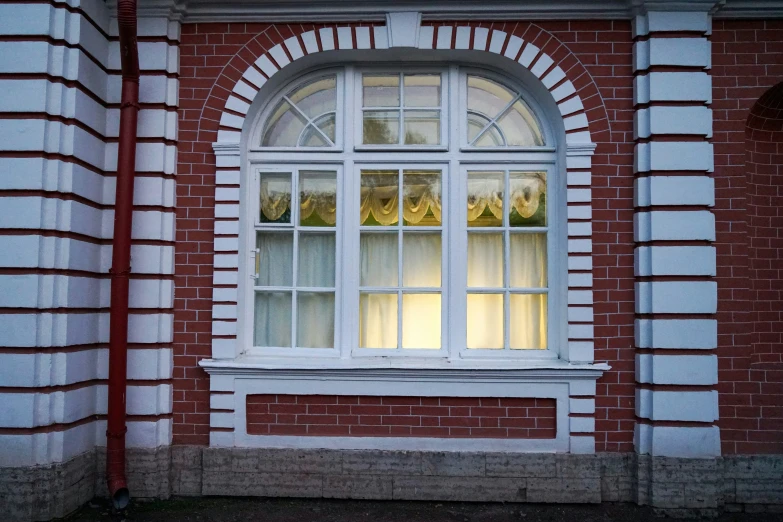 an empty window lit by a red lamp