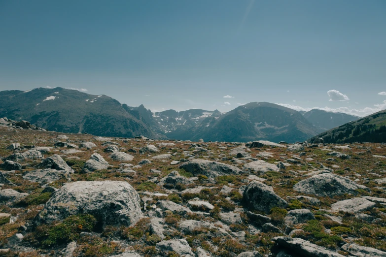 a rocky landscape with mountains in the background