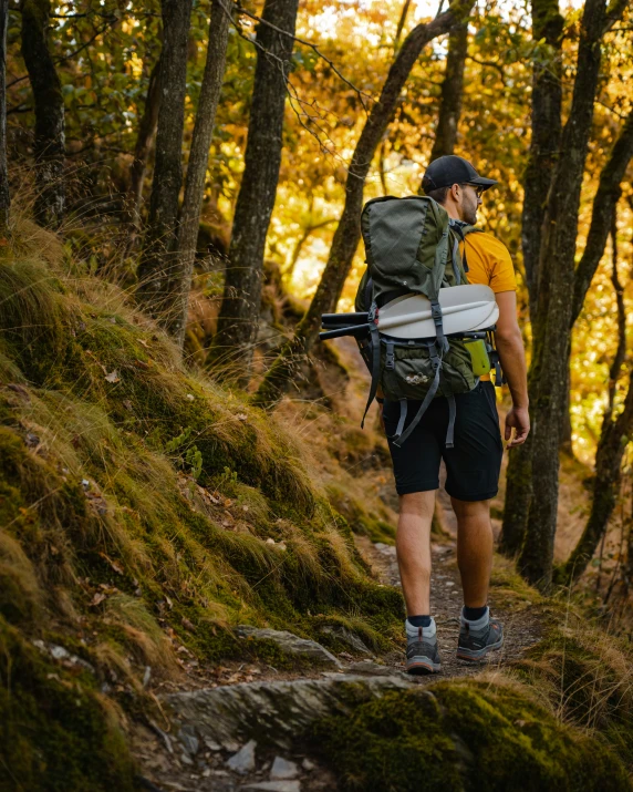 a man is hiking through a dense forest