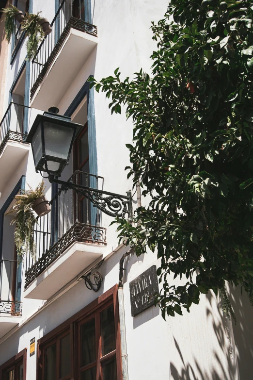 the outside of an apartment building with a lamp and balconies