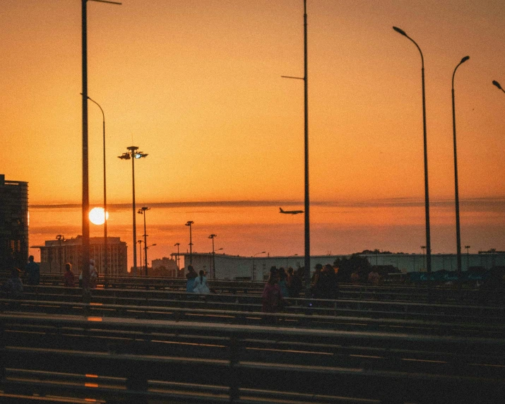 the sun sets over a field of benches