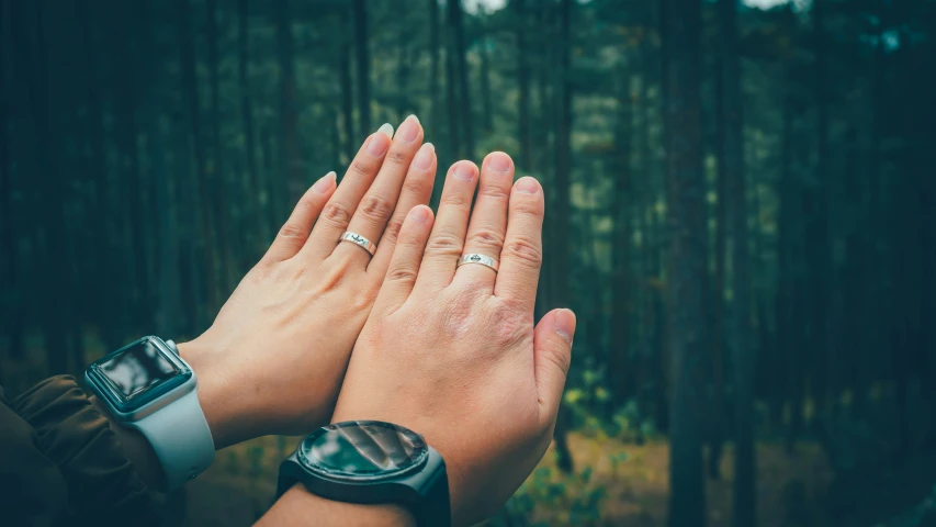 two hands that are standing together with their palms together