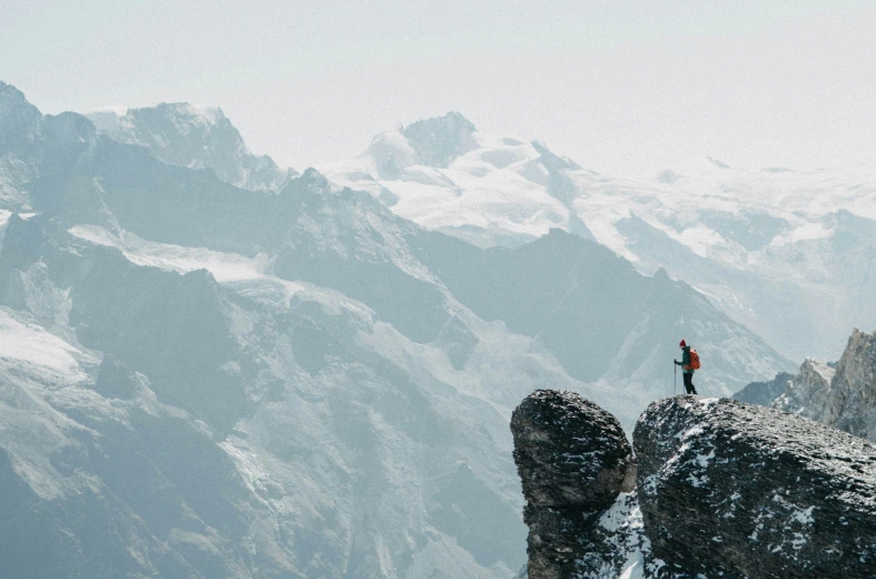 a person standing on top of a mountain overlooking mountains