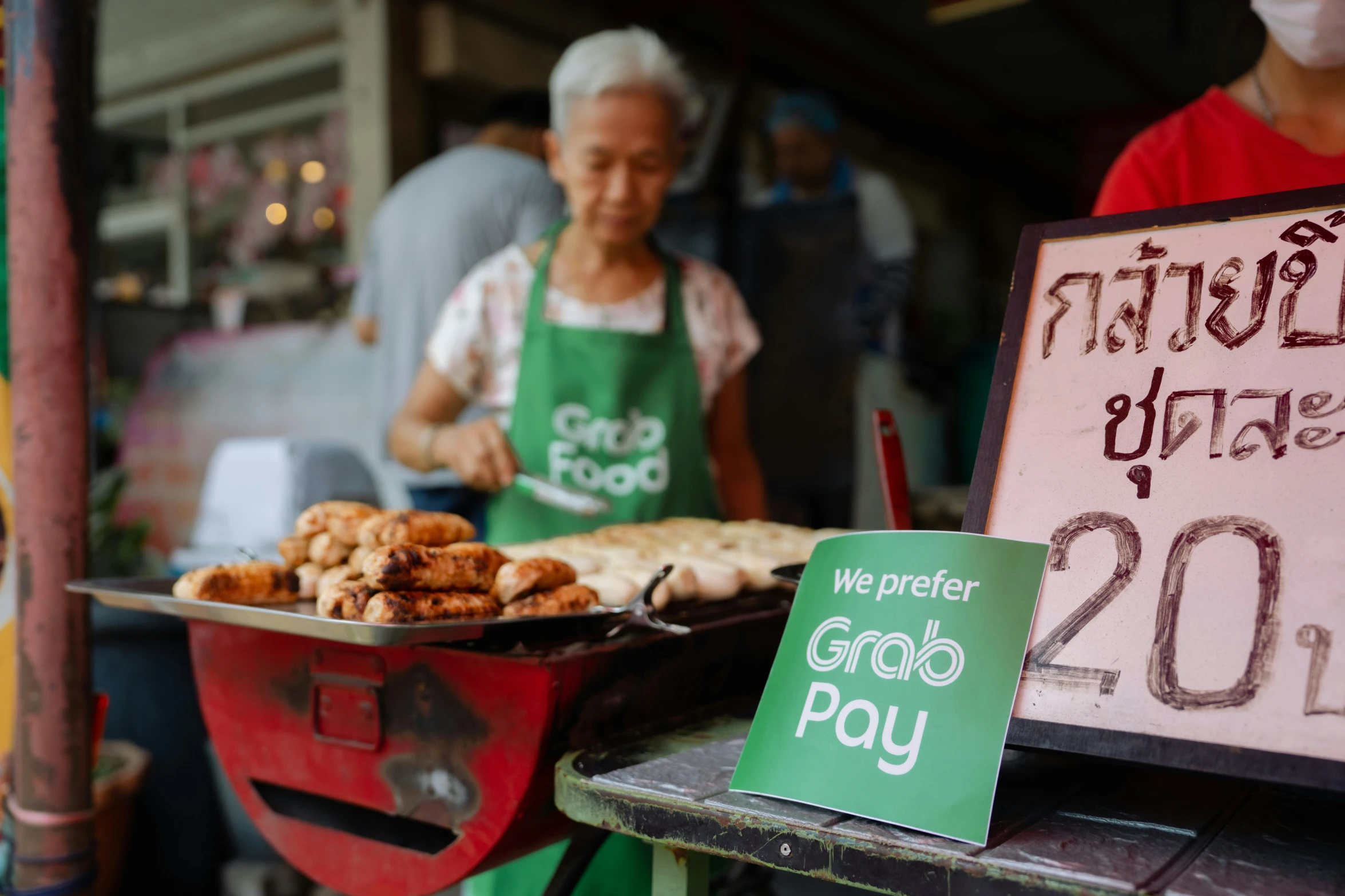 the people are selling their food outside by their respective vendors