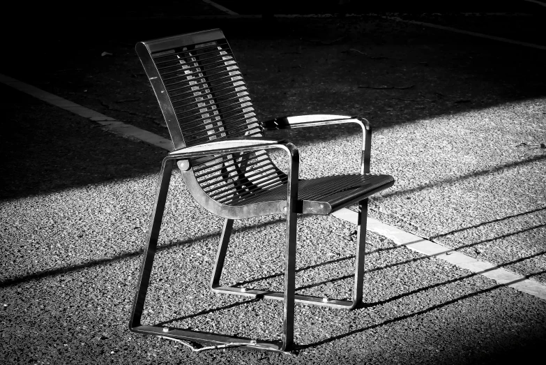 the shadow of a chair and a book on the ground