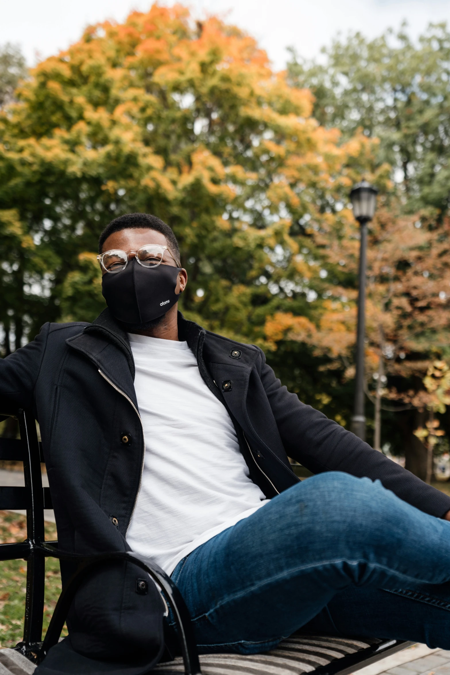 a man with a mask sitting on a bench