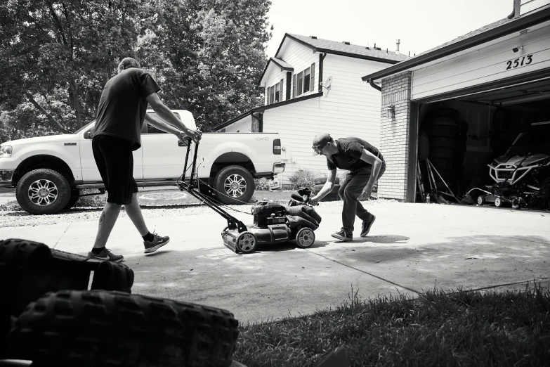 people are on a driveway doing soing in a yard