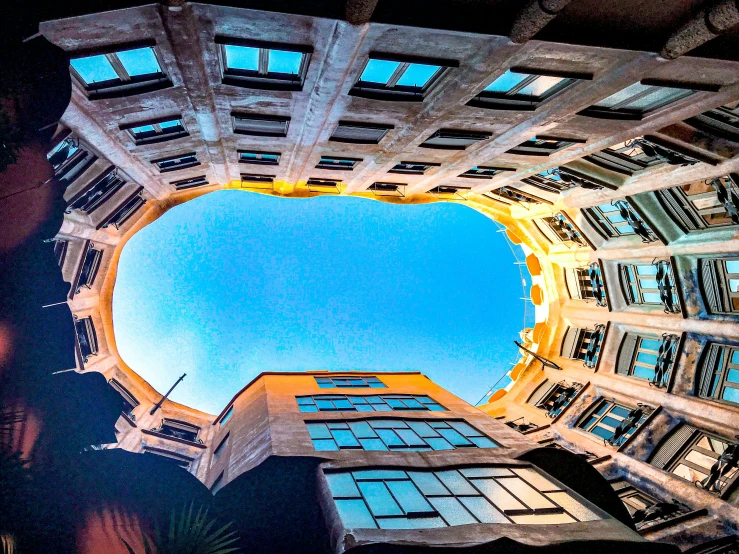 an image looking up into the sky through some windows