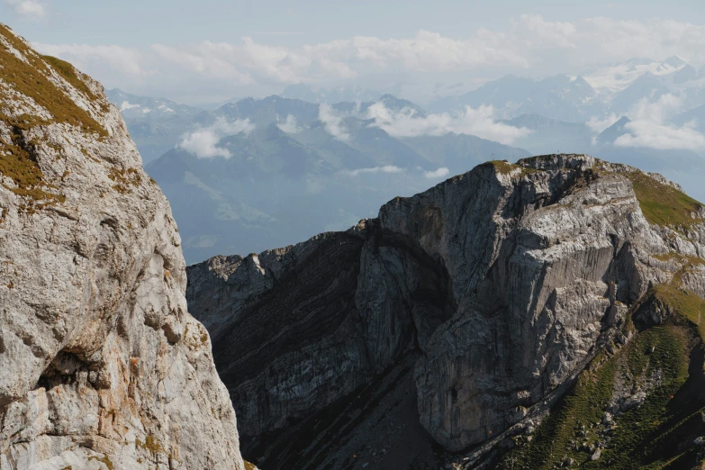 mountain climbings rise high on the rocks in front of a lake