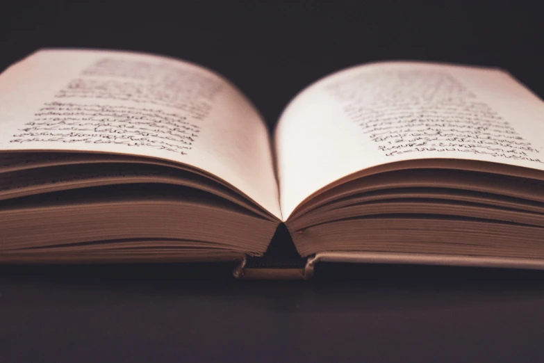 an open book with the pages visible on a table