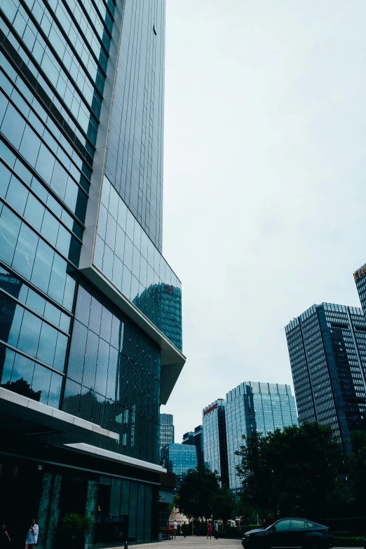 a large building with a lot of windows next to a city street