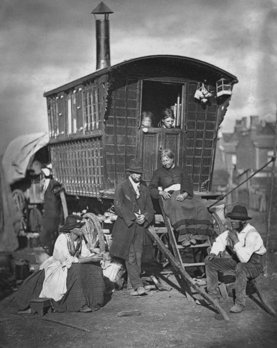 several men sit next to a train