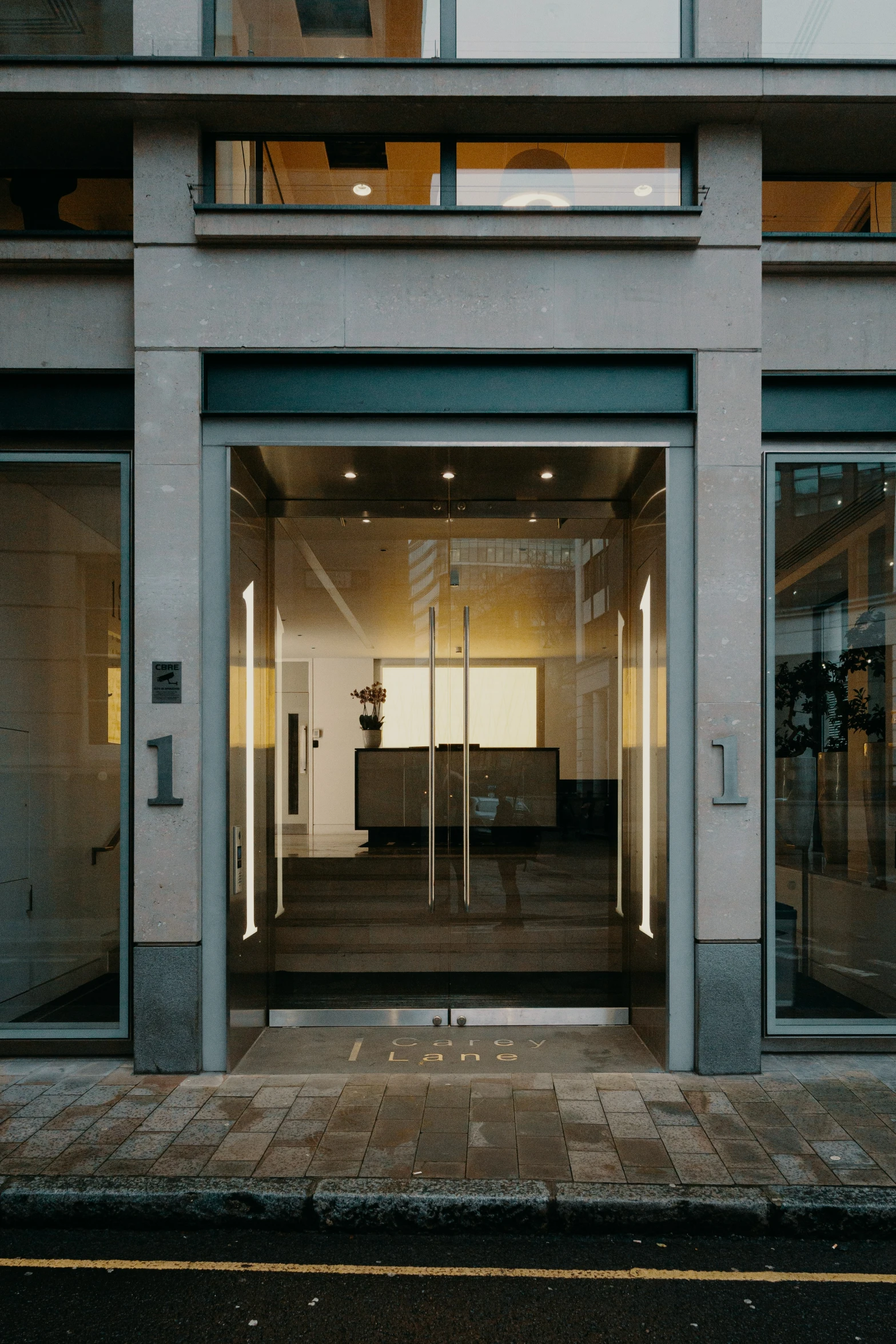 an empty open door in to a large white building