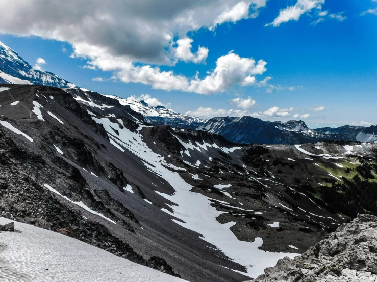 a skier with a jacket and skis skiing down a mountain