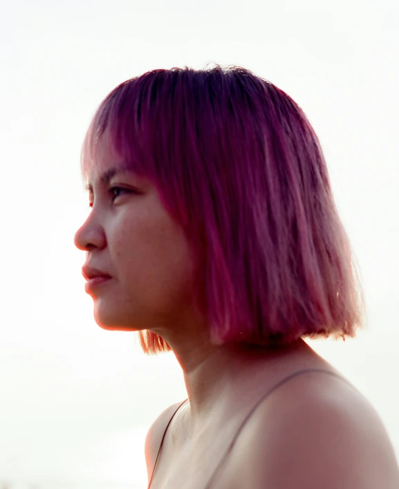 a woman with short, pink hair and purple bangs