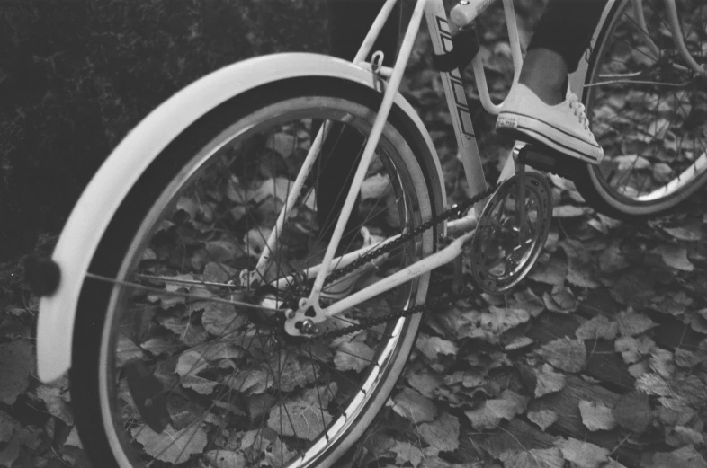 black and white pograph of a person's legs on a bike