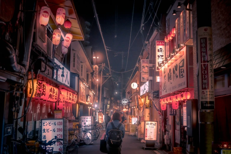 a man walks down a narrow asian street