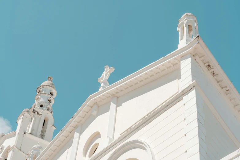 the cathedral steeple is white and has ornate details