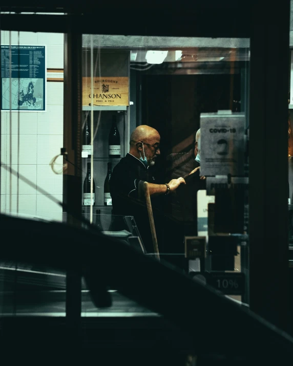 a man with an apron looking at the store