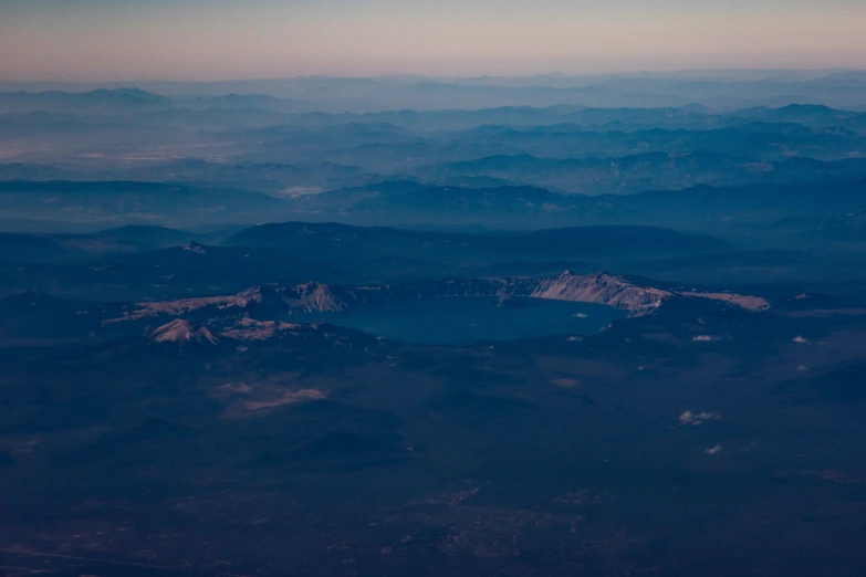 a view from the airplane of mountains and lakes