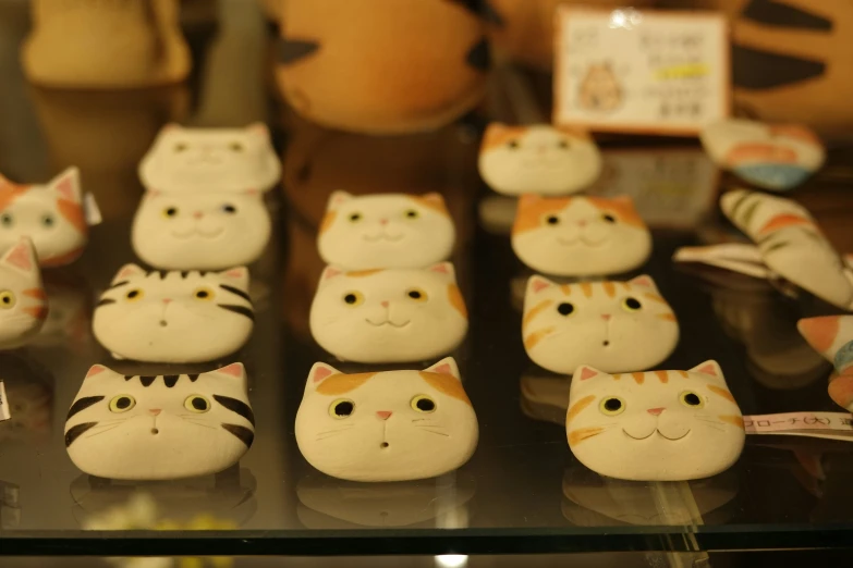 there are several different kinds of toy cats on display