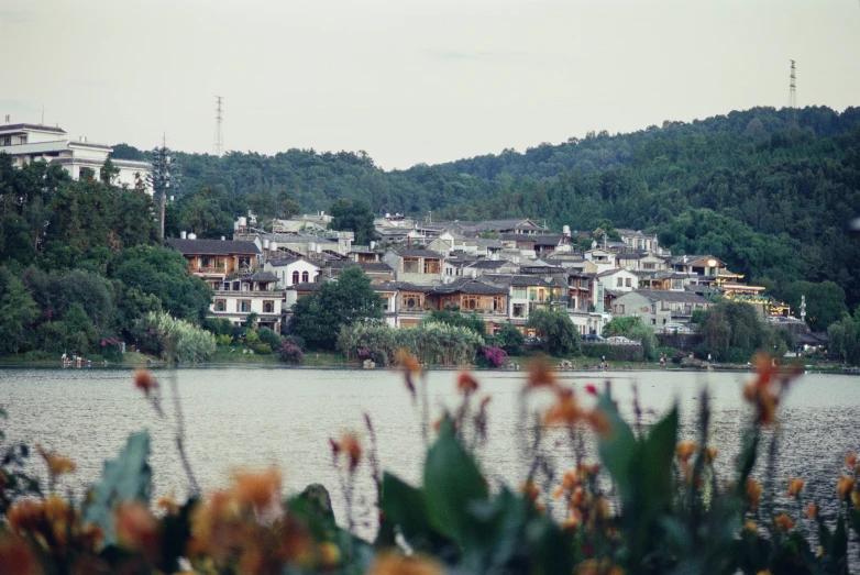 a village along the water's edge with some buildings on top of it