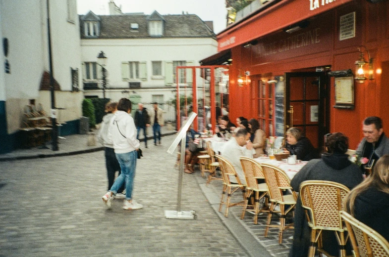 people sitting at a table in a courtyard cafe