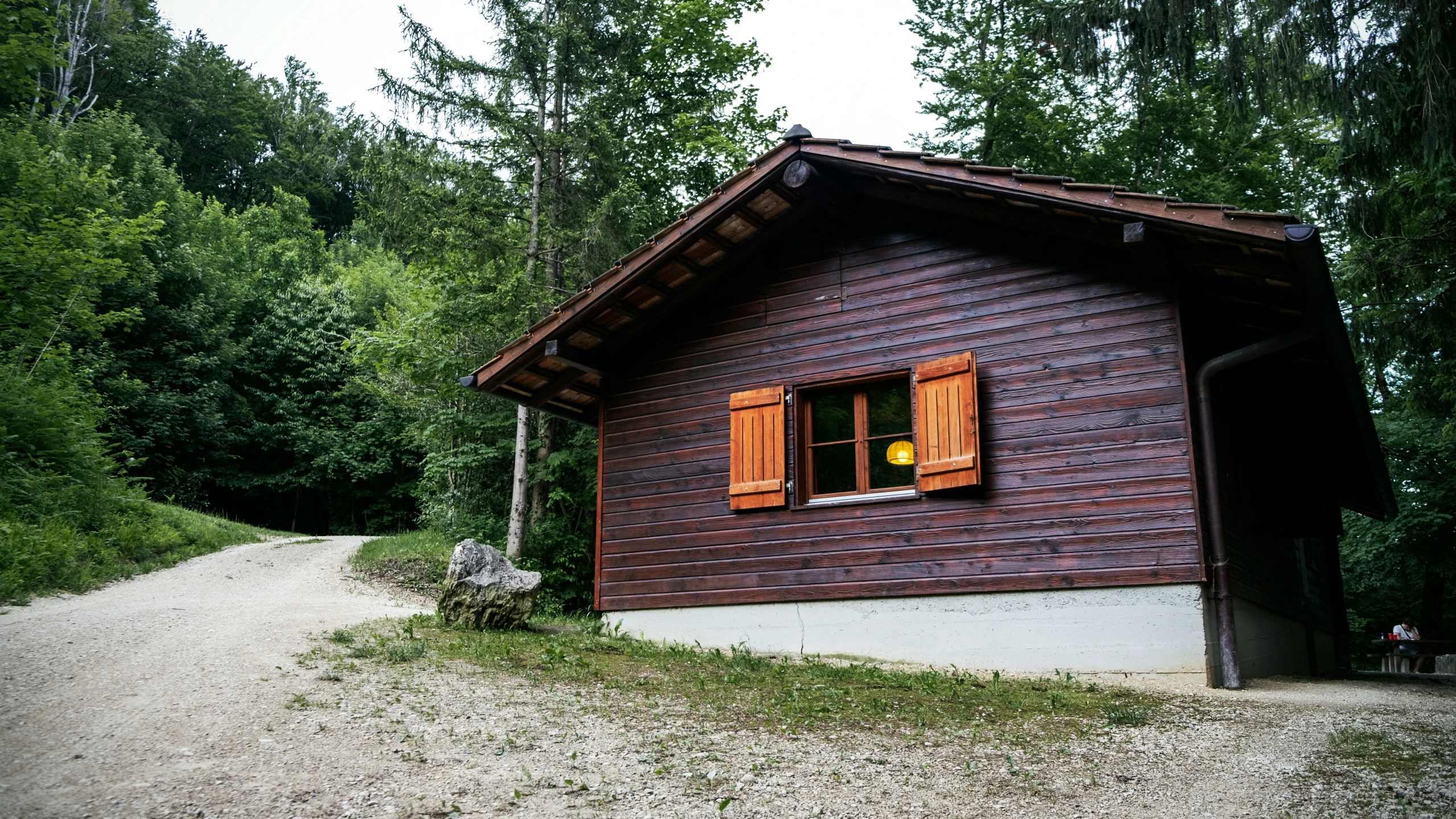 a house with an orange window on top of it