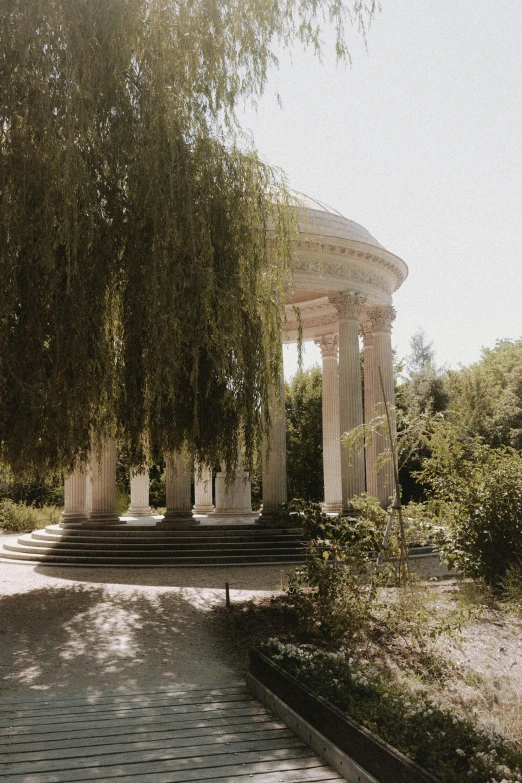 large white structure near brick walkway in park