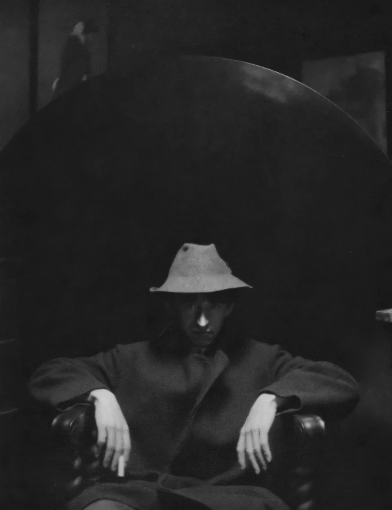 a person wearing a hat on top of a chair