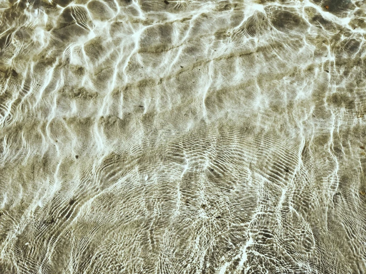 a view of the sand from underneath water