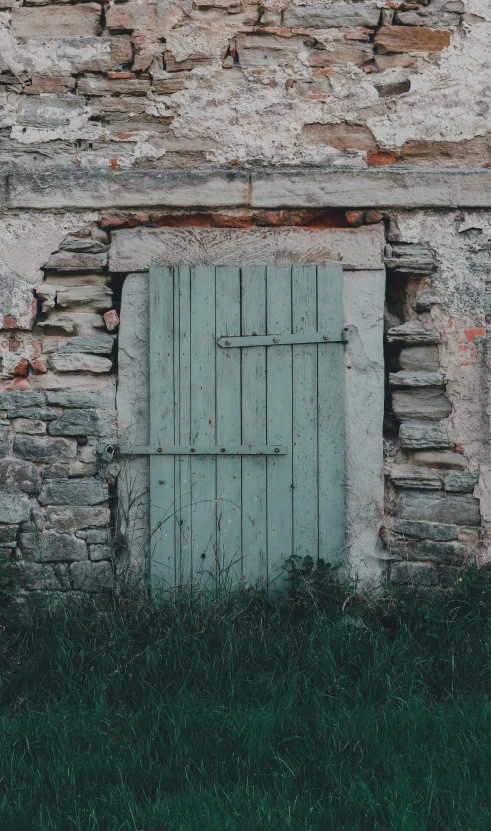 a stone building with an old, wooden door