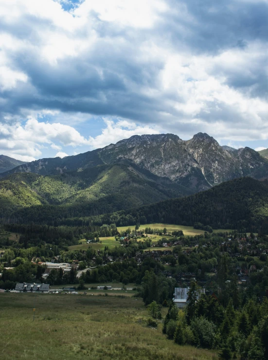 the mountain tops are covered with some clouds