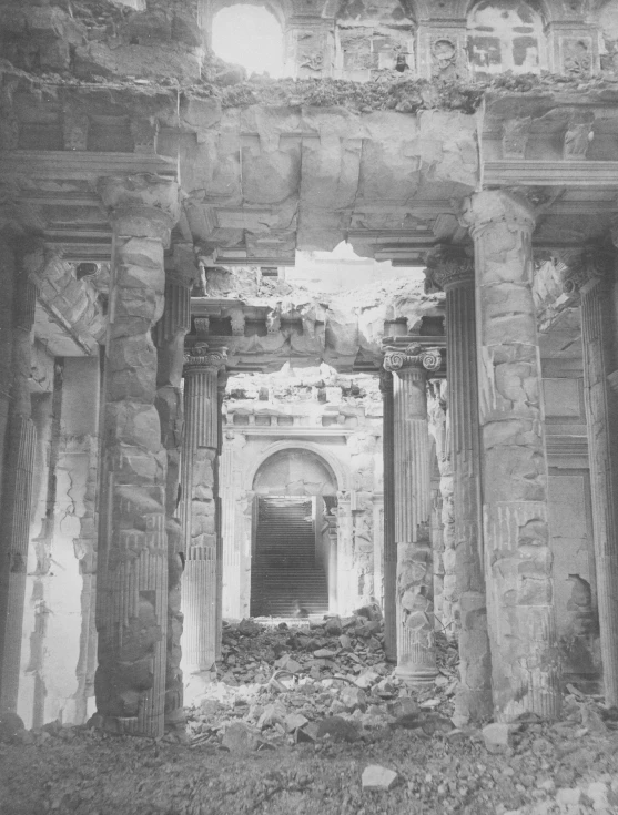 an arch in the ruins is surrounded by debris