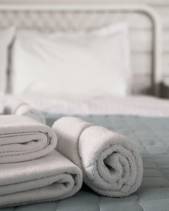 towels and pillows lay out on a bed