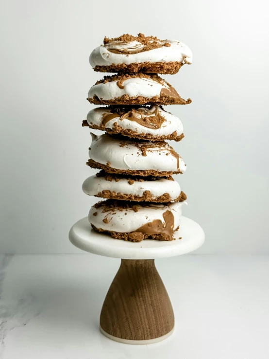 a cake stand with seven chocolate - covered cookies and white icing