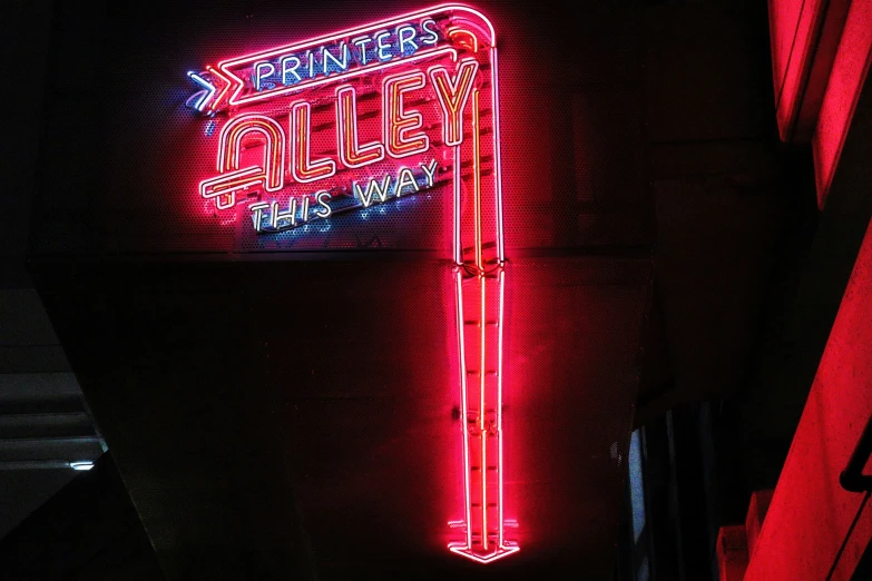 a sign has been lit up for sale on the side of the building