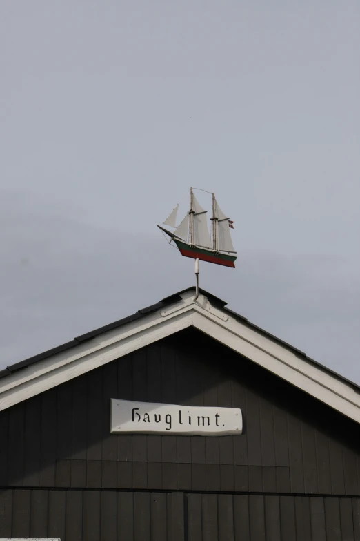a wooden ship is up in the air above a sign