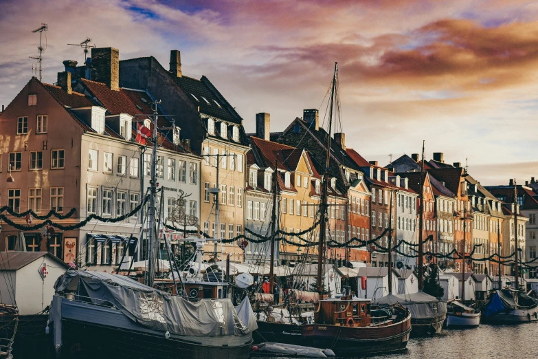 a river full of ships parked in front of buildings