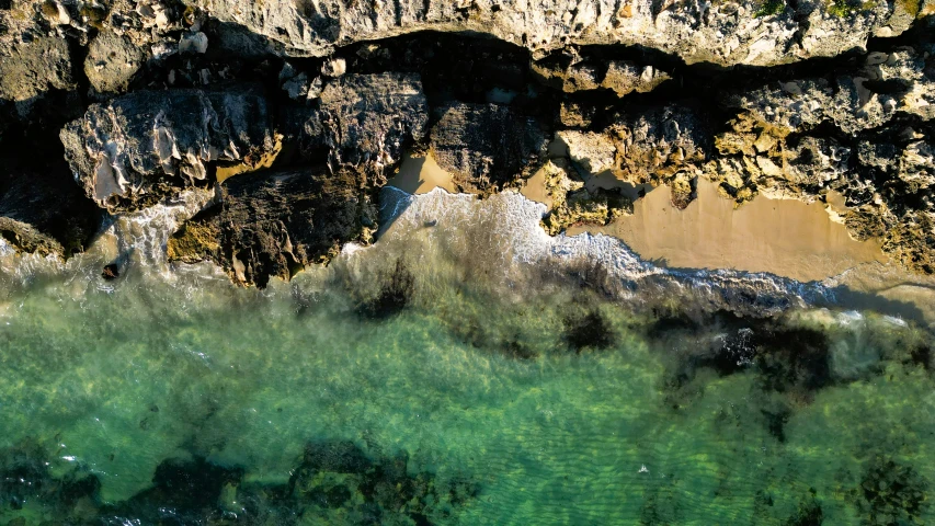 an aerial view of a river at the base of a mountain