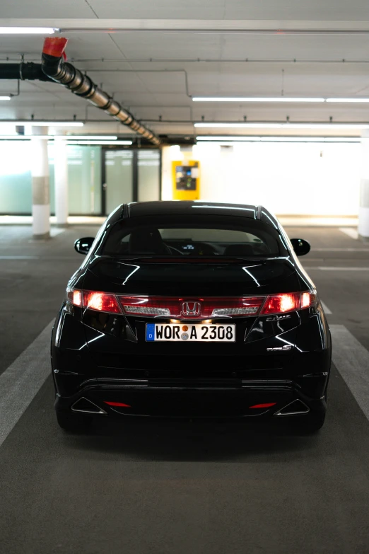 the back end of a black honda civic coupe