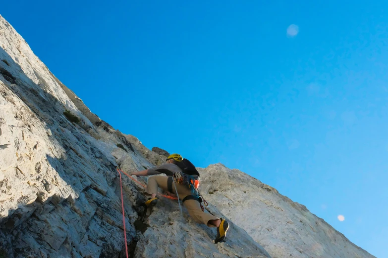 a man on top of a rock on a steep cliff