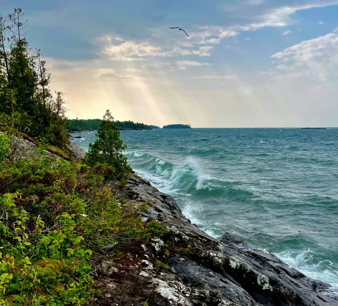 there is a wave crashing on the shore