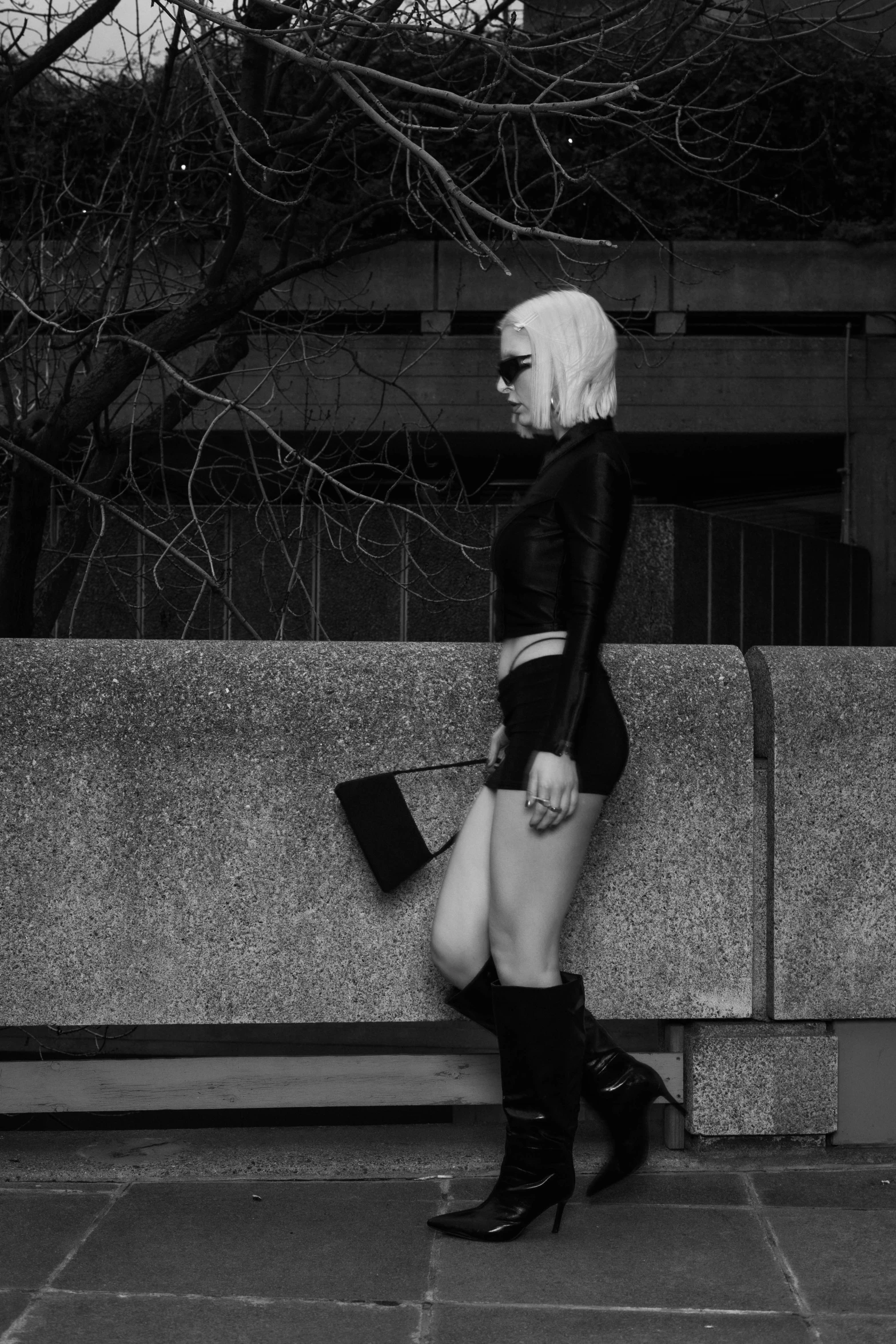 a woman with white hair, dressed in high boots