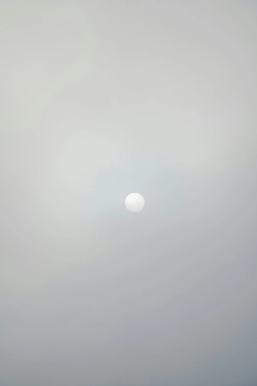 a kite flying through the air on a cloudy day